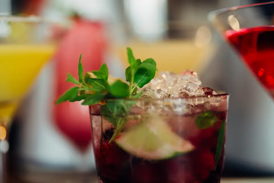 Colourful cocktails with fresh fruit and mint on a bar counter
