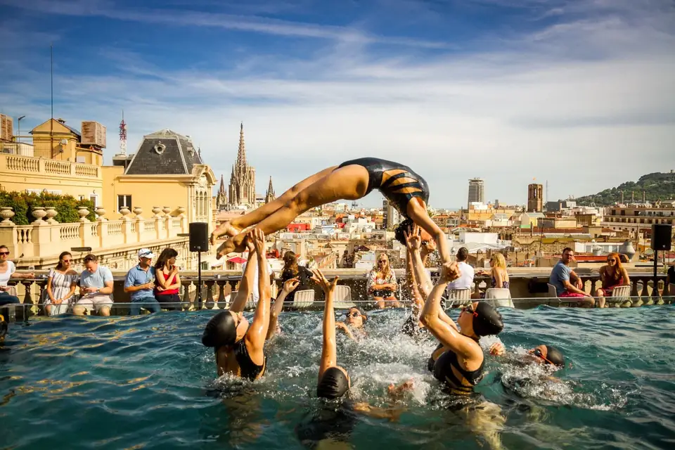 Synchronized swimmers in the rooftop pool at Ohla Barcelona during Hotel Terrace Week
