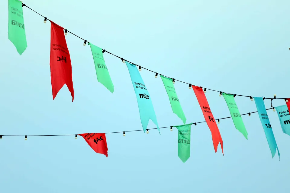 Festa Major de Sant Pere bunting strung against a blue sky in El Masnou