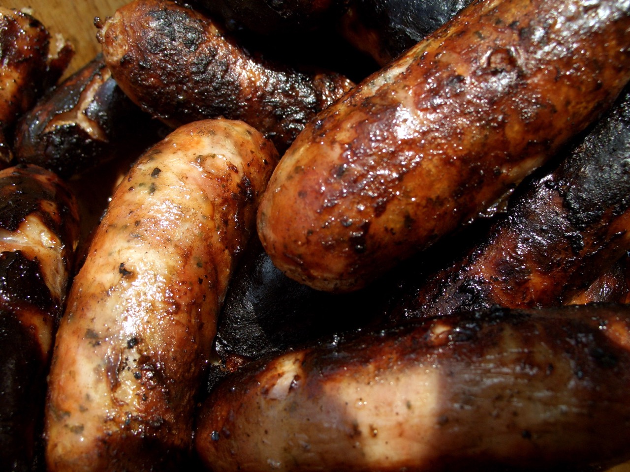 Close up of grilled sausages roasted over hot coals