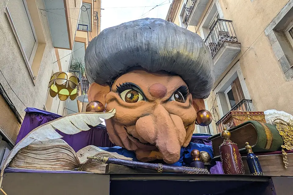 A giant papier-mâché head among the street decorations of Festa Major de Gràcia