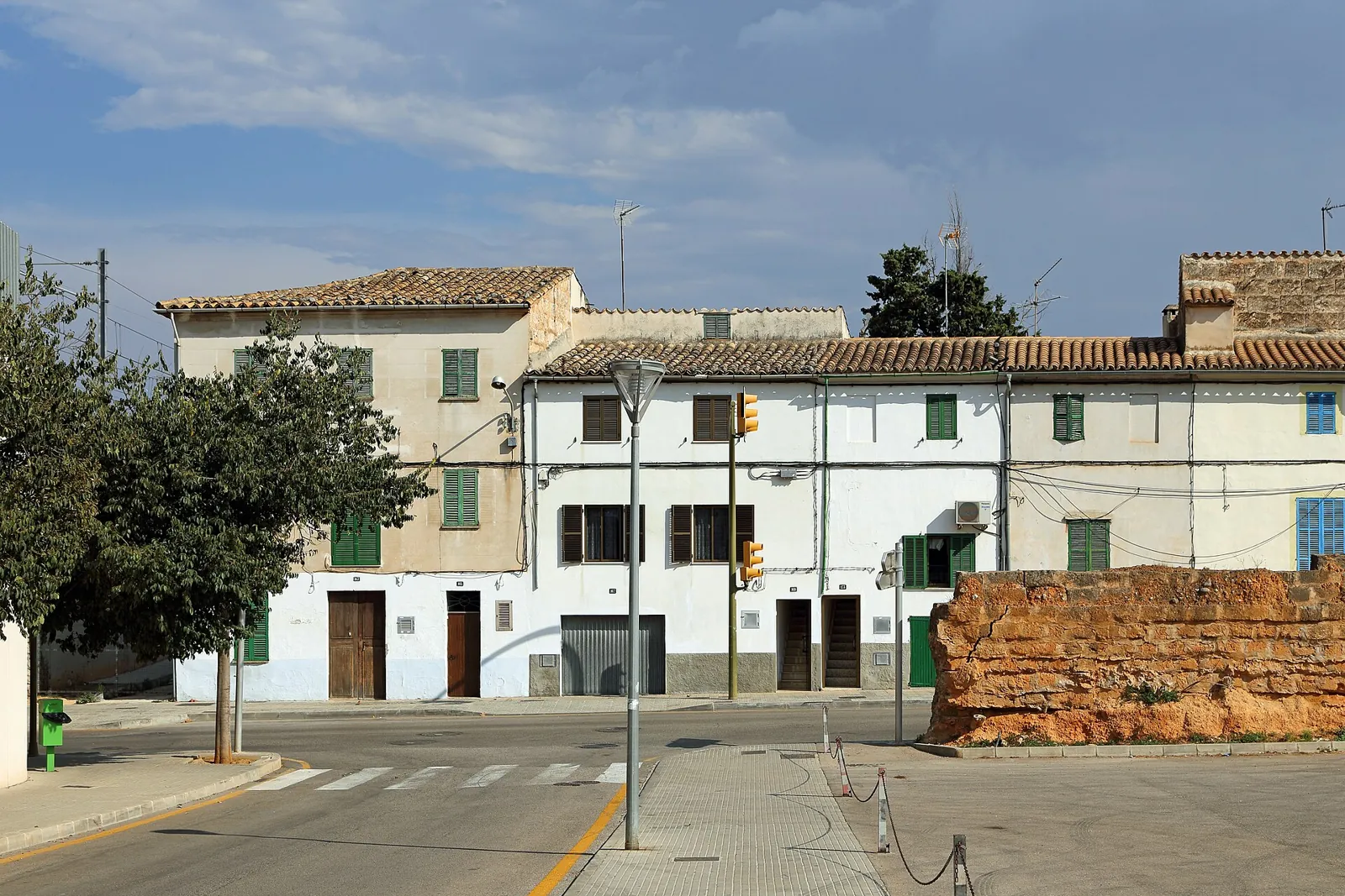 Traditional houses and a stretch of old wall on a street in Inca, Mallorca