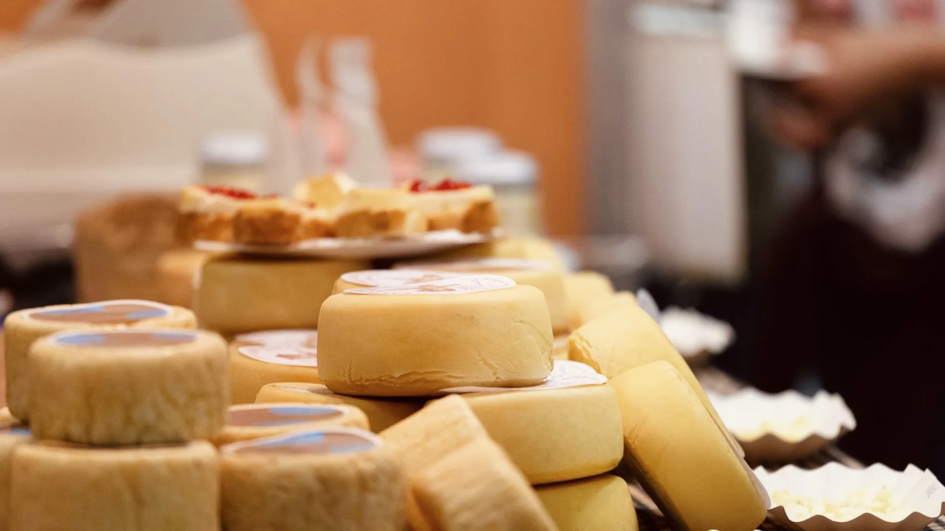 Stacked artisanal Pyrenean cheese rounds at Fira de Sant Ermengol