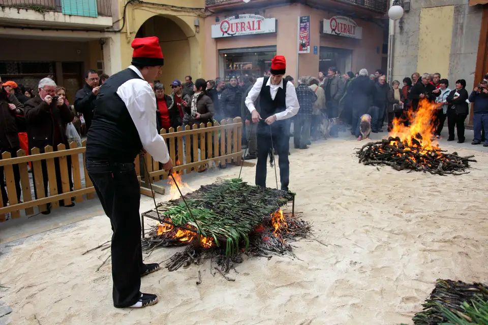 Calçots being grilled over open fires in the street at the Gran Festa de la Calçotada in Valls