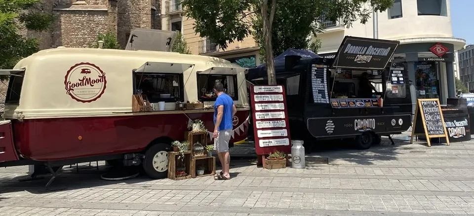 Vintage food trucks with menu boards at a Happy Food Trucks street-food festival