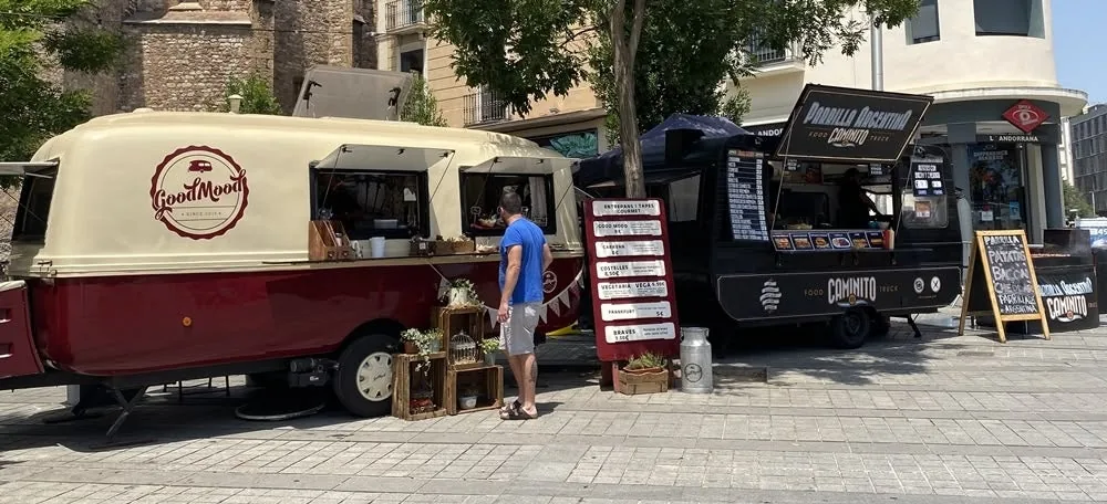 Vintage food trucks with menu boards at a Happy Food Trucks street-food festival