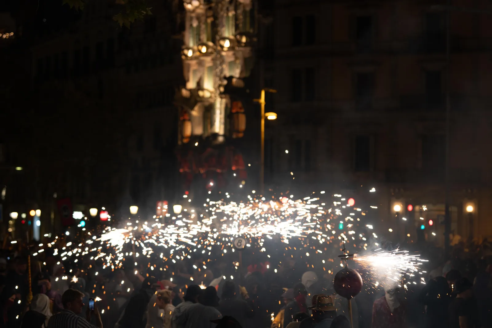 Correfoc sparks lighting up the crowd at night during La Mercè