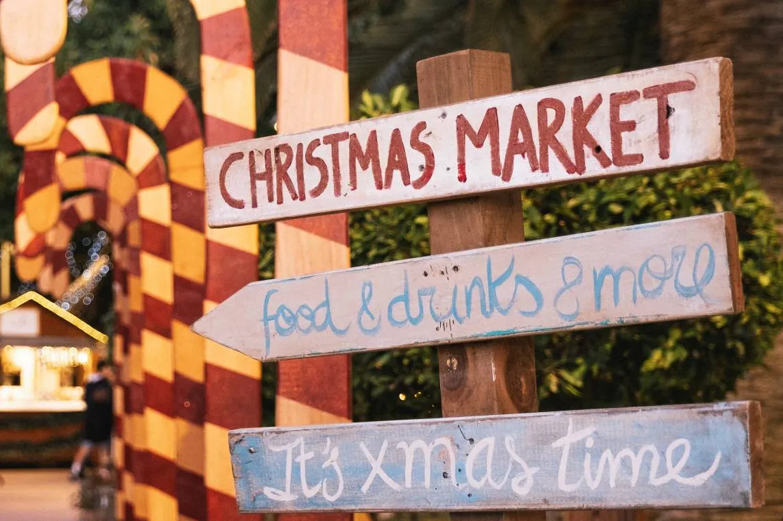 Signs reading Christmas Market and food & drinks & more at a previous Puerto Portals Christmas Market