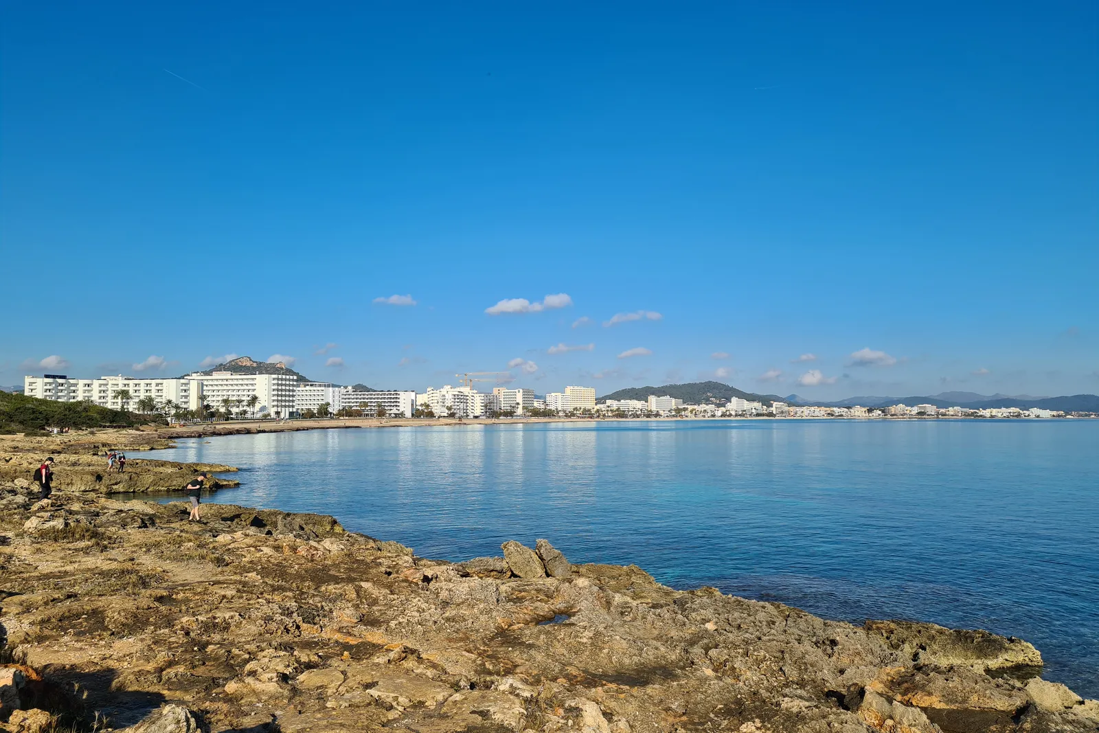 Cala Millor bay seen from the rocks, with the resort's seafront behind