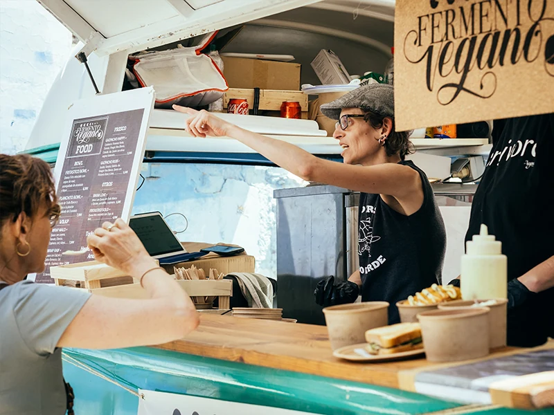 Vendor at a vegan food truck at VegFest Barcelona