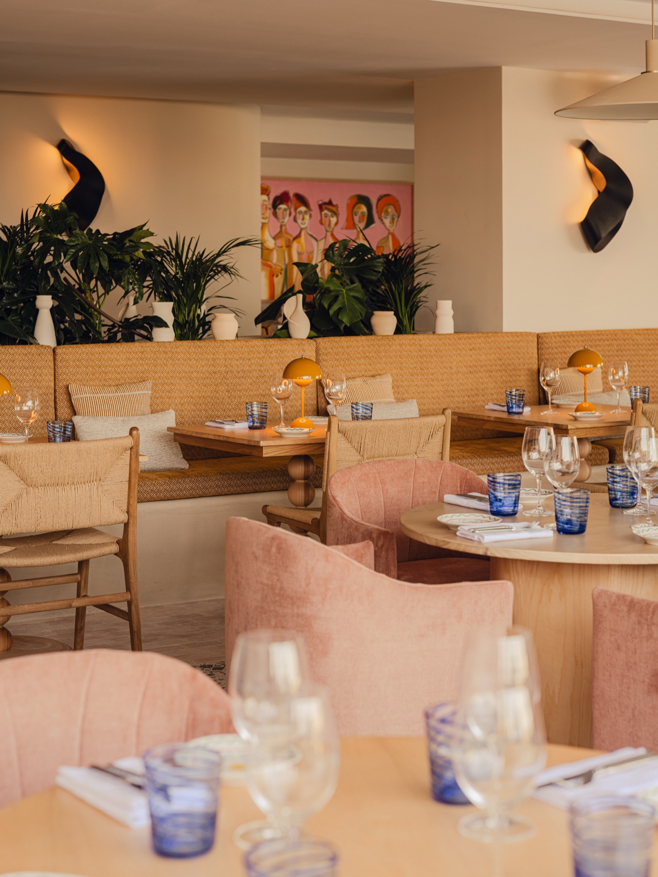 ONDA restaurant dining room at Aethos Mallorca with pink chairs and woven banquette seating
