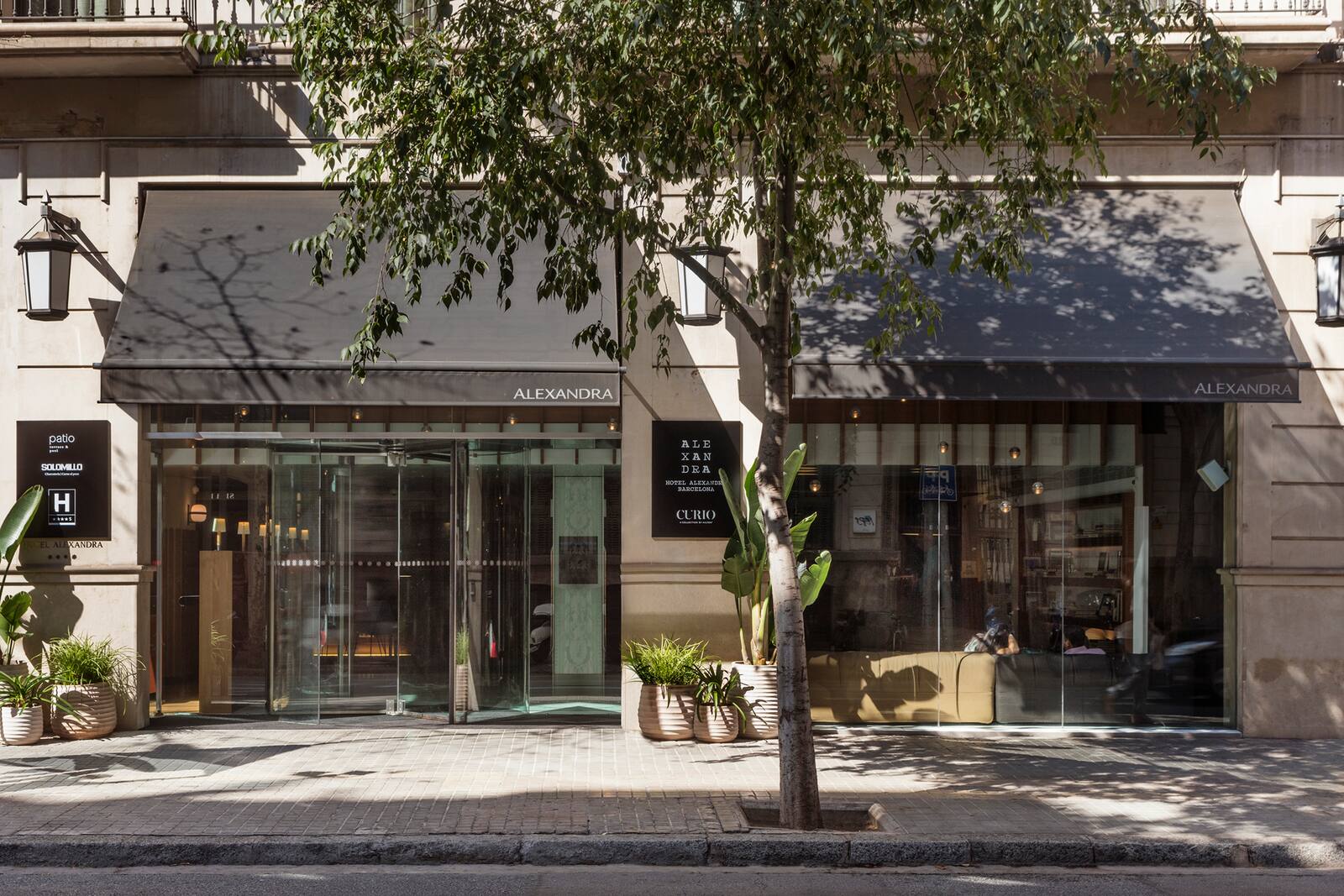 Alexandra Barcelona street-level facade with awnings and signage