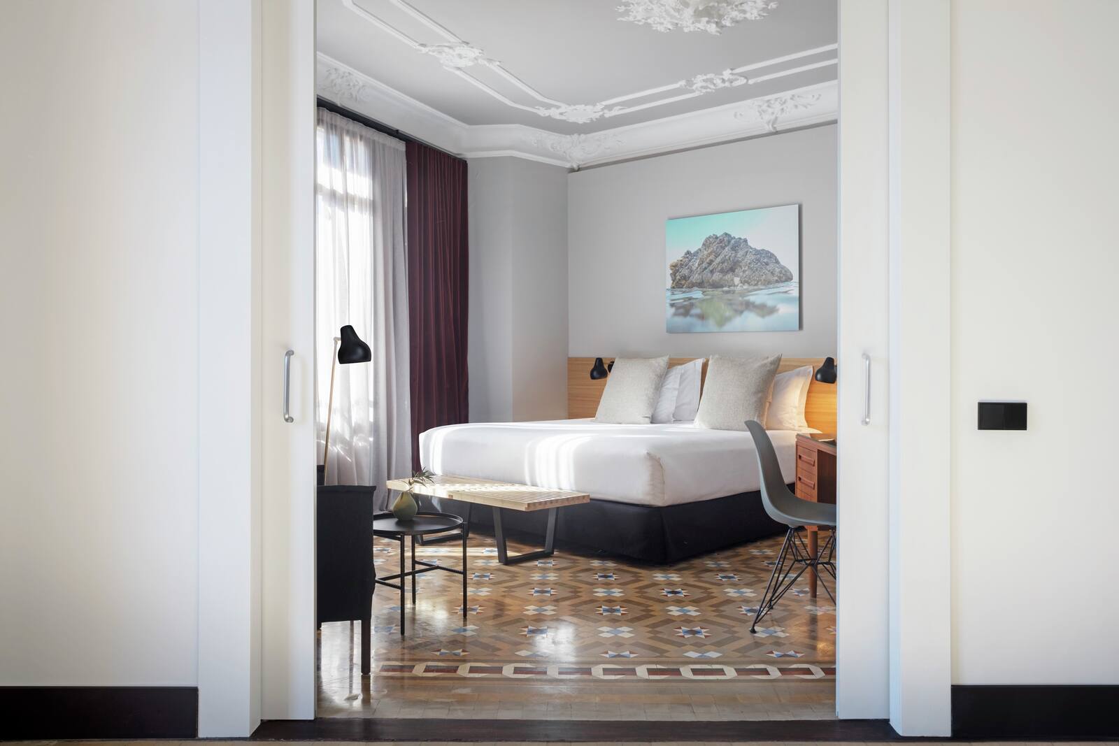 Suite bedroom with an ornate plaster ceiling and a mosaic-tile floor