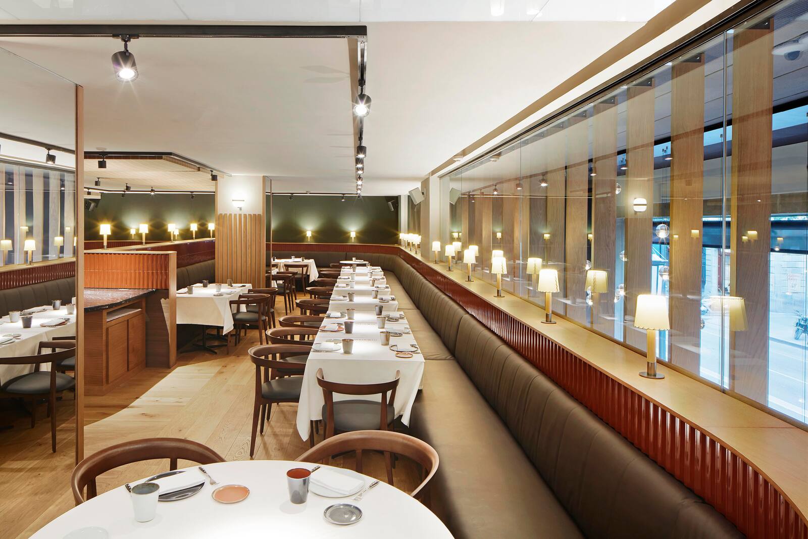 Hotel restaurant dining room with banquette seating along a glass facade