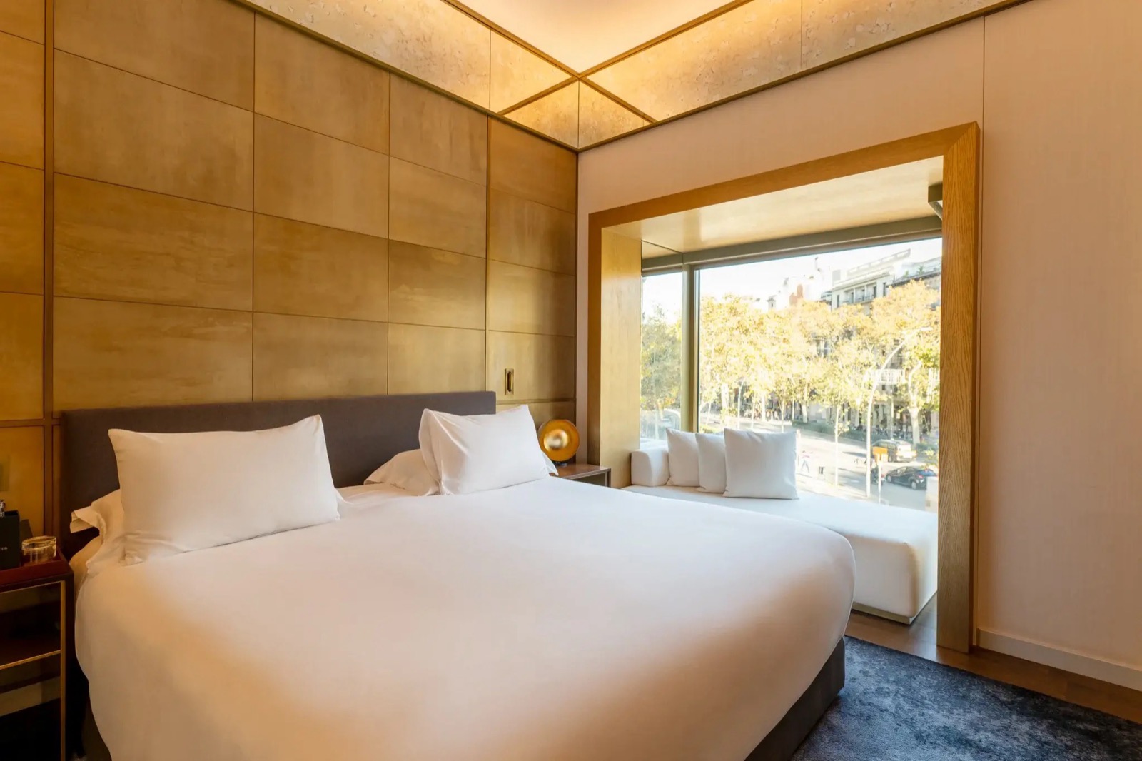 Suite bedroom with a built-in window nook overlooking the street