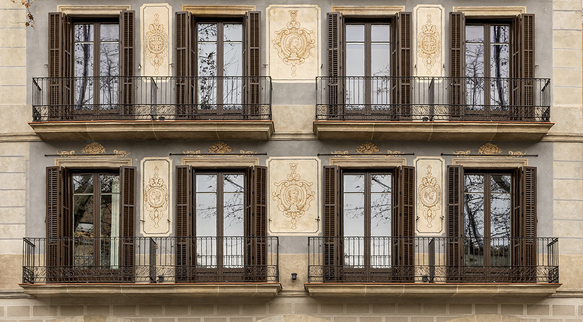 Ornate Eixample-style building facade with wrought-iron balconies
