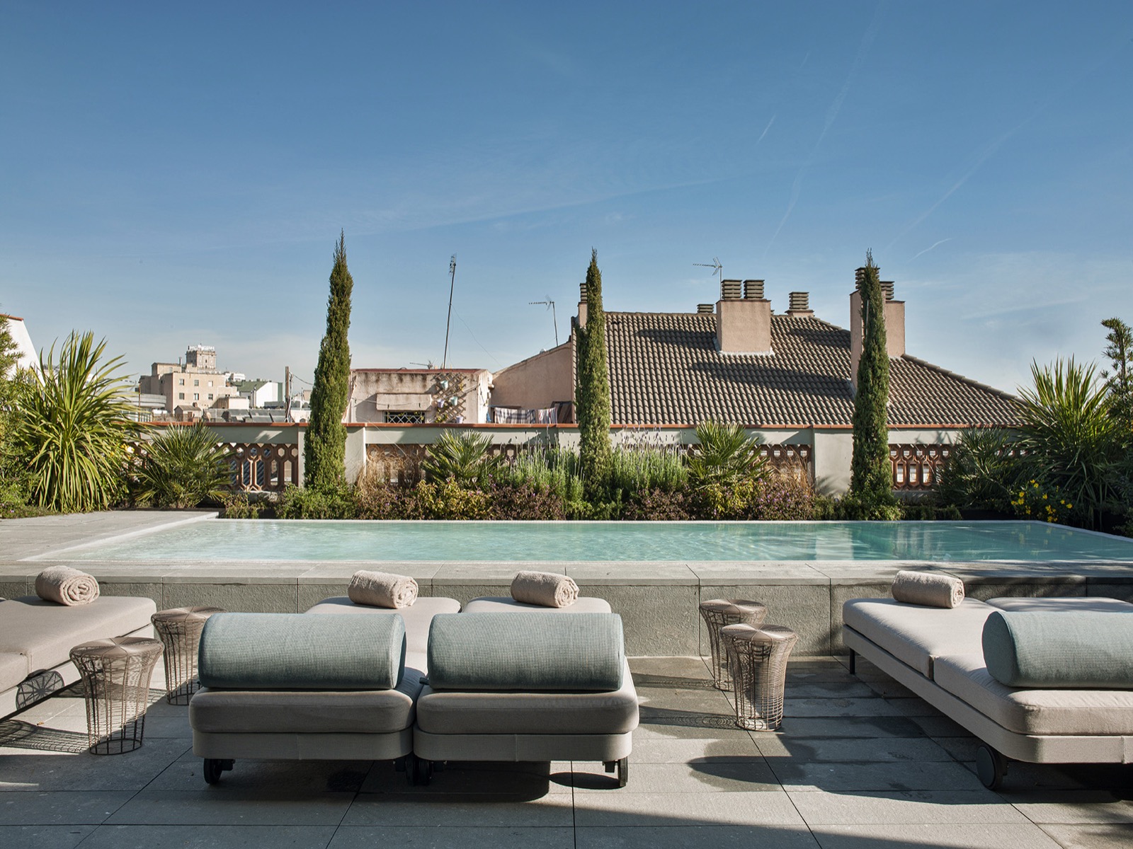 Rooftop pool with loungers overlooking neighbouring Barcelona rooftops