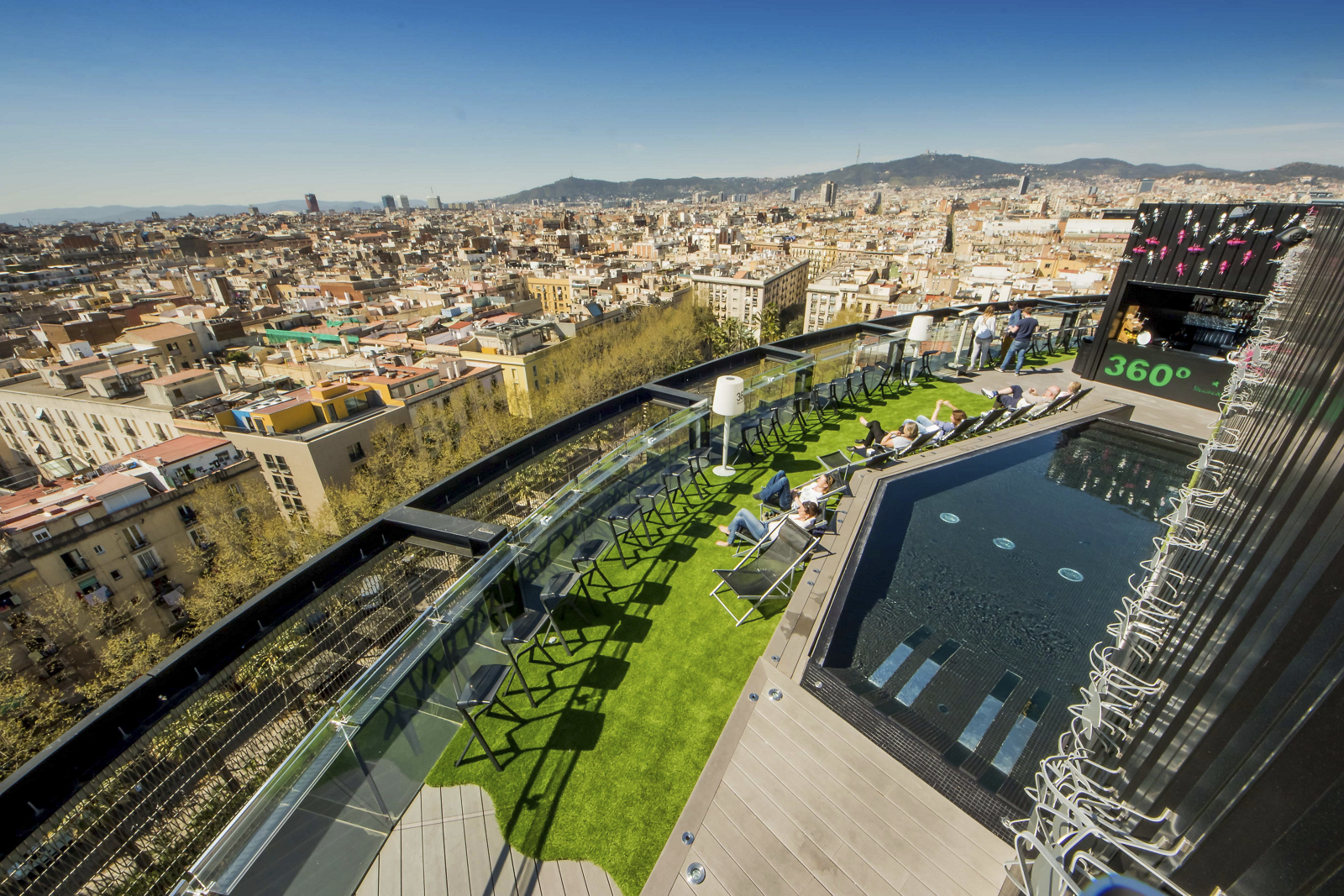 Rooftop pool and terrace with a panoramic Barcelona skyline view