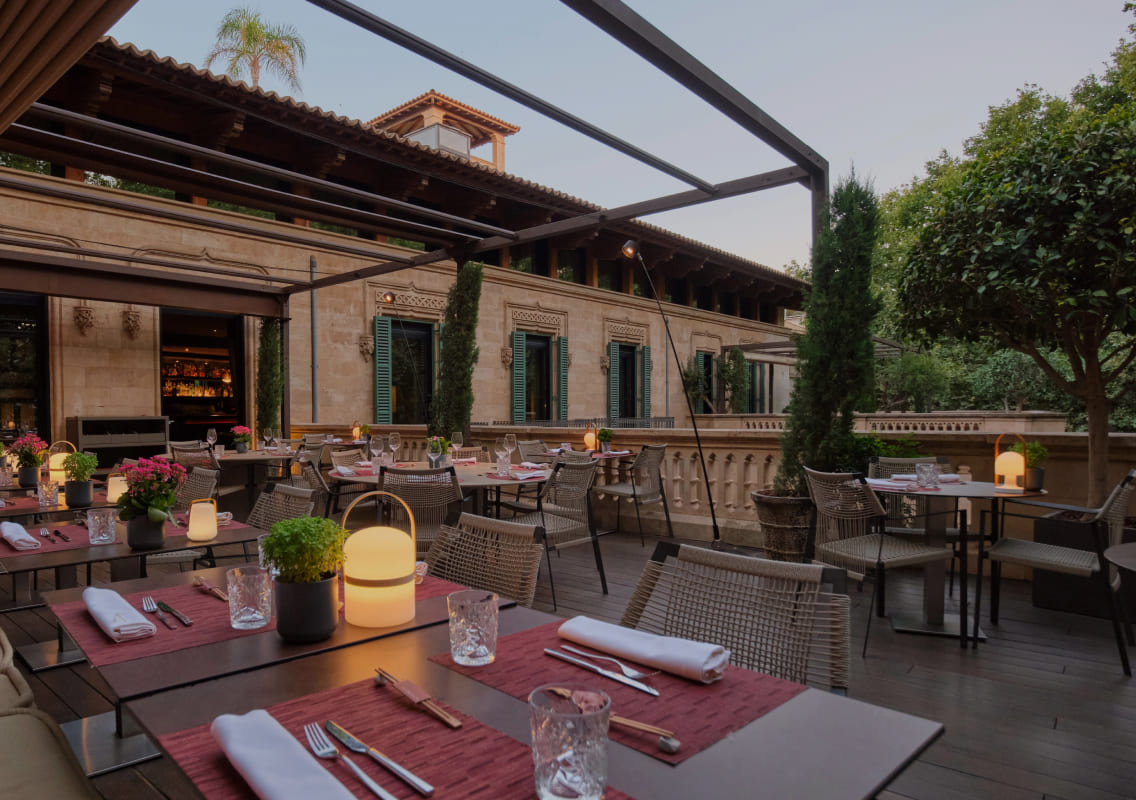 Rooftop restaurant terrace at Can Alomar with cathedral spires in view