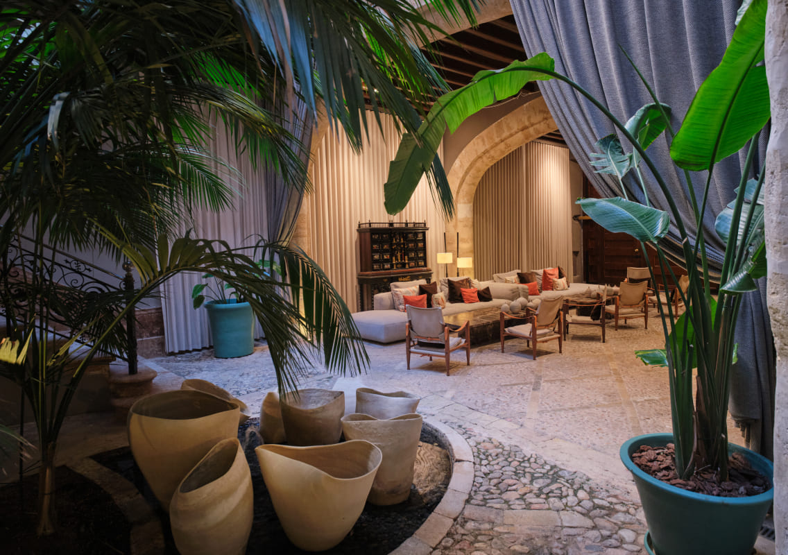 Palm-shaded lounge seating in the hotel's covered courtyard