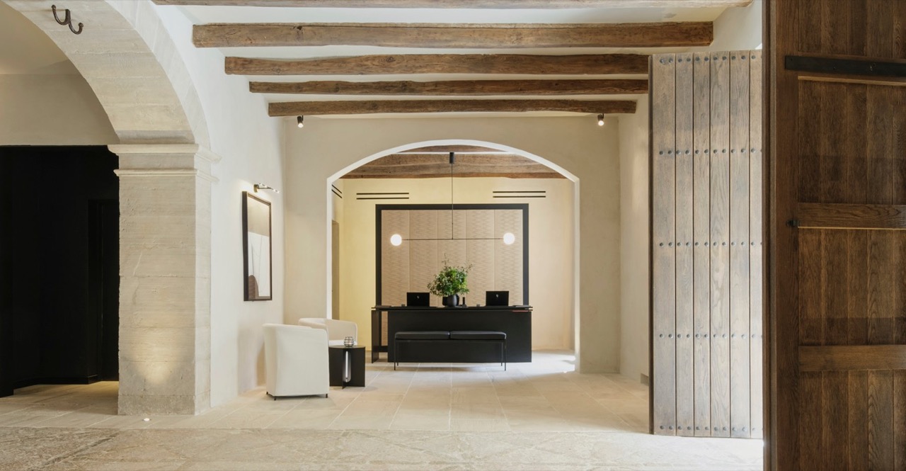 Can Ferrereta's reception area with stone archways and exposed wood beam ceilings