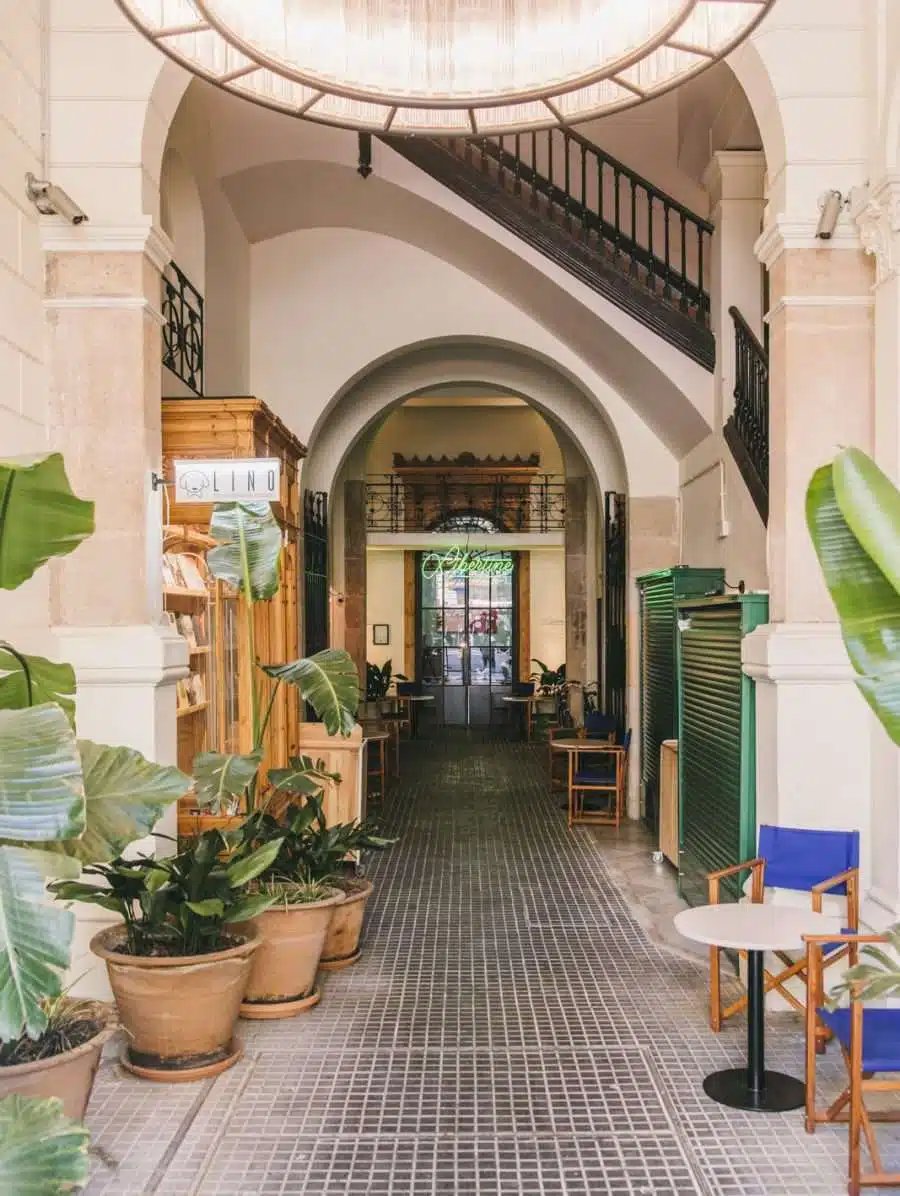 Interior arched passageway with a staircase toward the Libertine bar