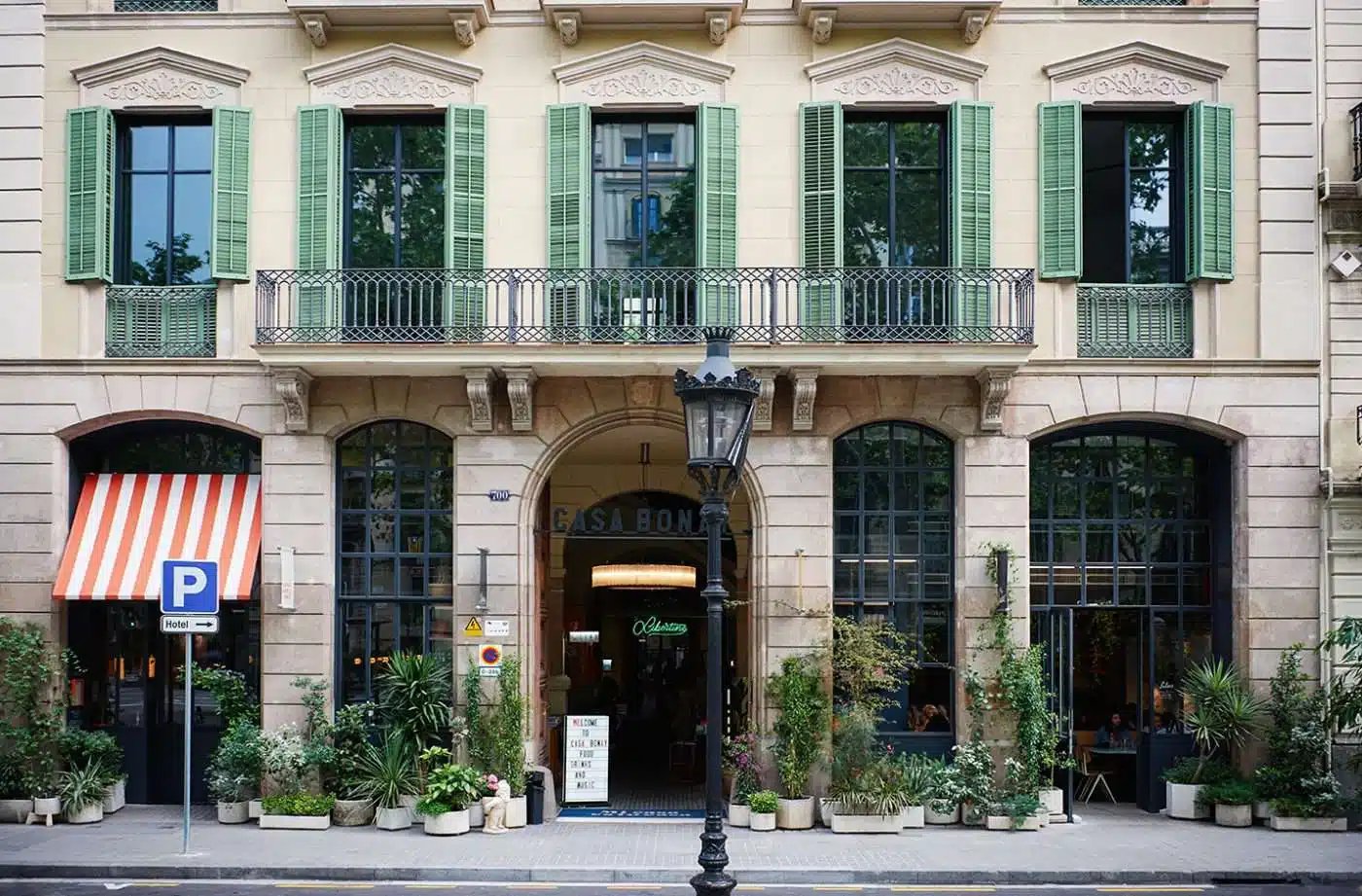 Street-level view of the Casa Bonay building facade with green shutters