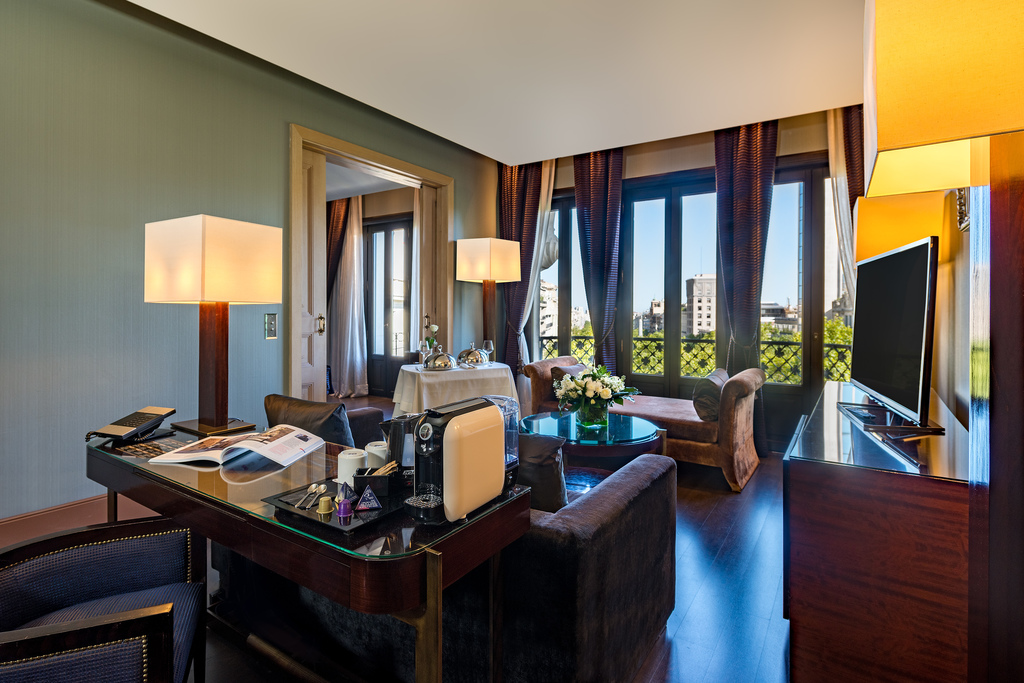 Senior suite living area with city views through French balcony doors