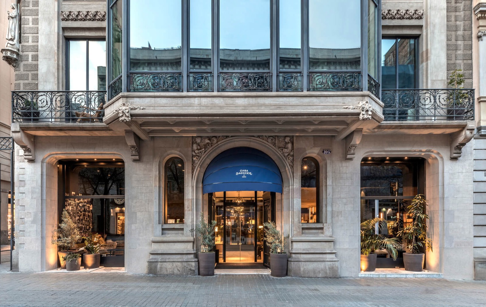 Hotel Casa Sagnier's historic stone facade with a blue entrance awning