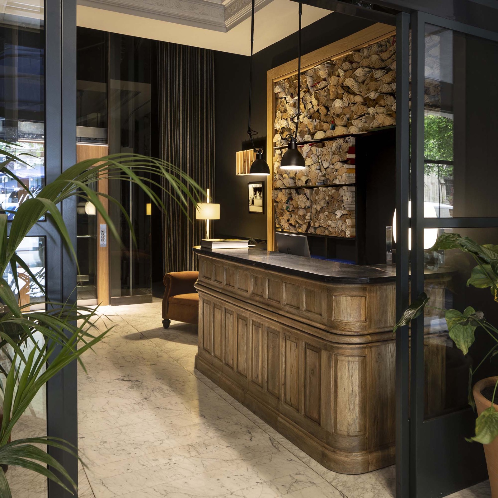 Reception with wood paneling and a sculptural shell-motif art wall