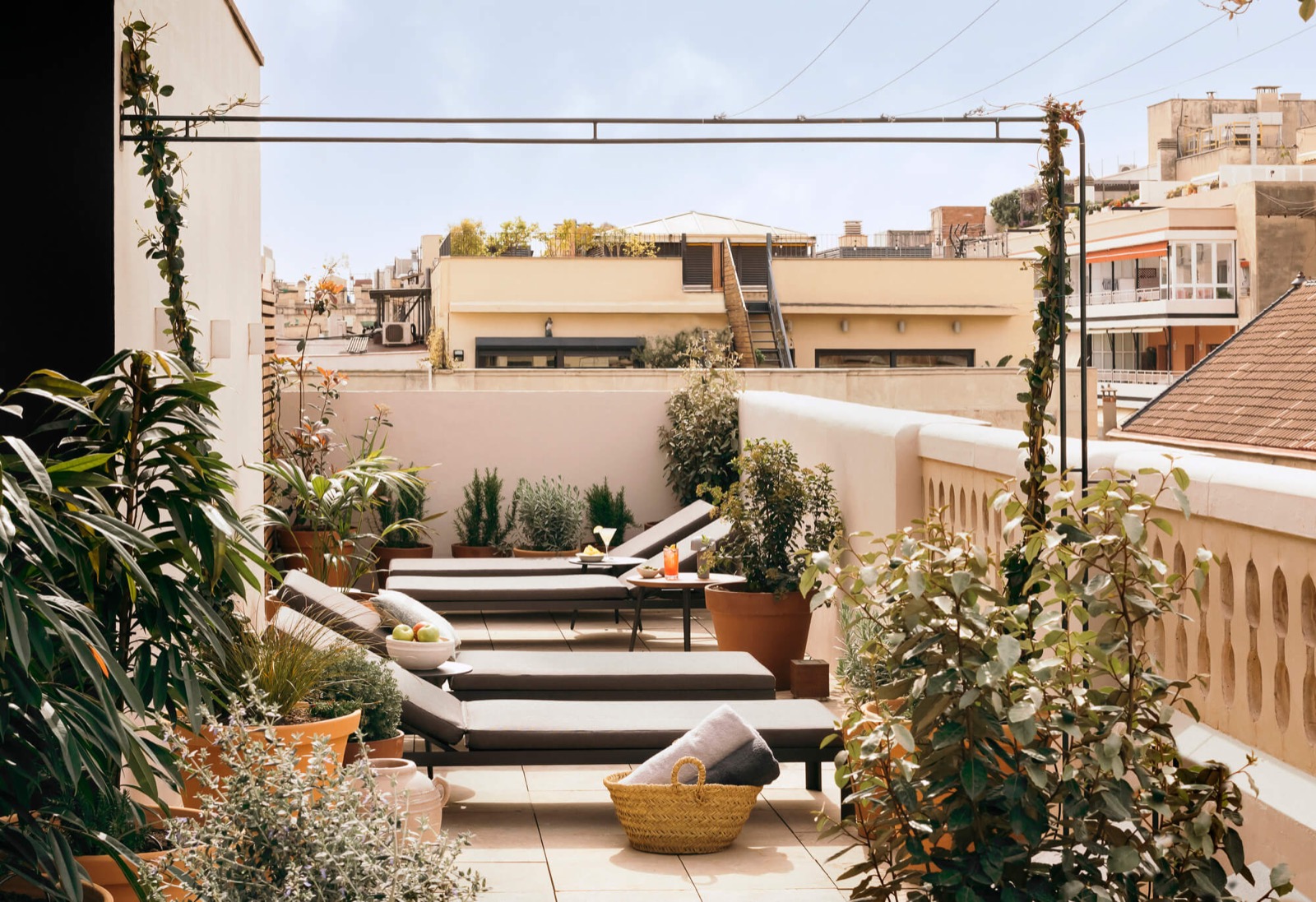 Rooftop terrace with sun loungers overlooking Eixample rooftops