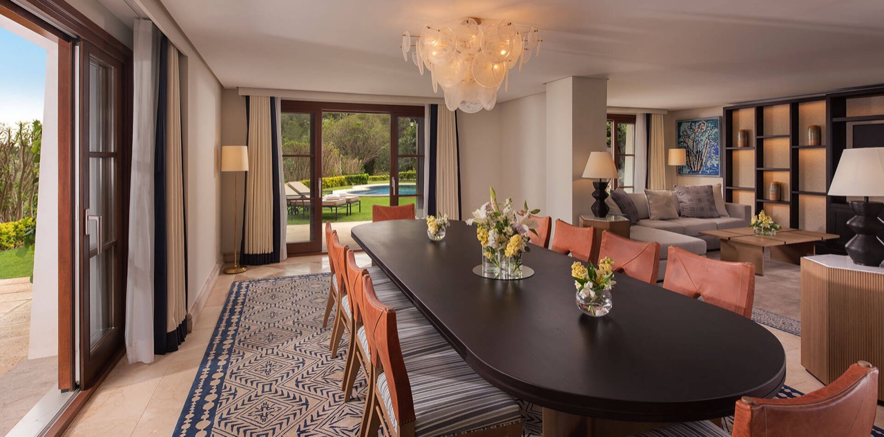 Villa dining room opening onto a private garden and pool