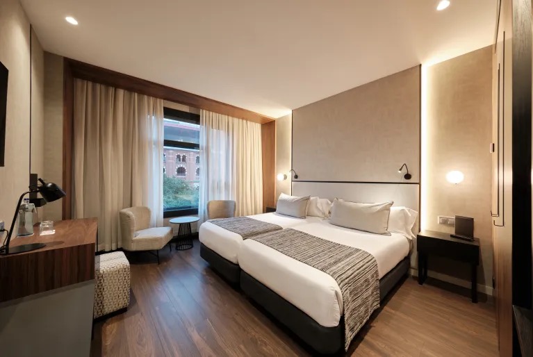 Double room with twin beds and a city-facing window