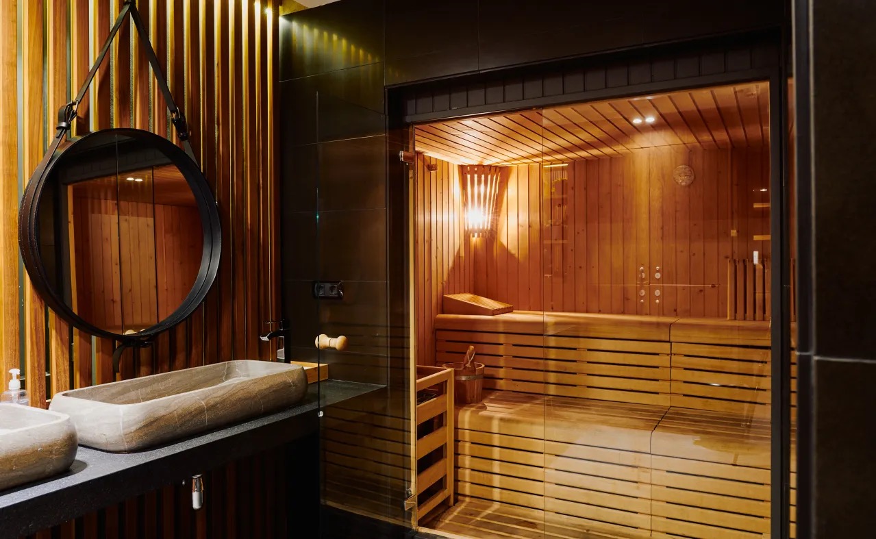 Spa area with a sauna and stone vessel sinks