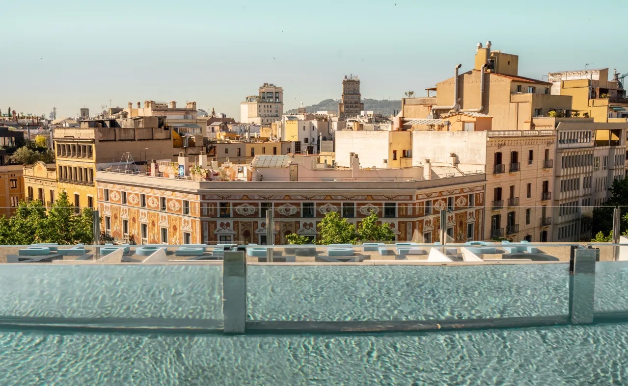Rooftop pool edge with an Eixample rooftop skyline view