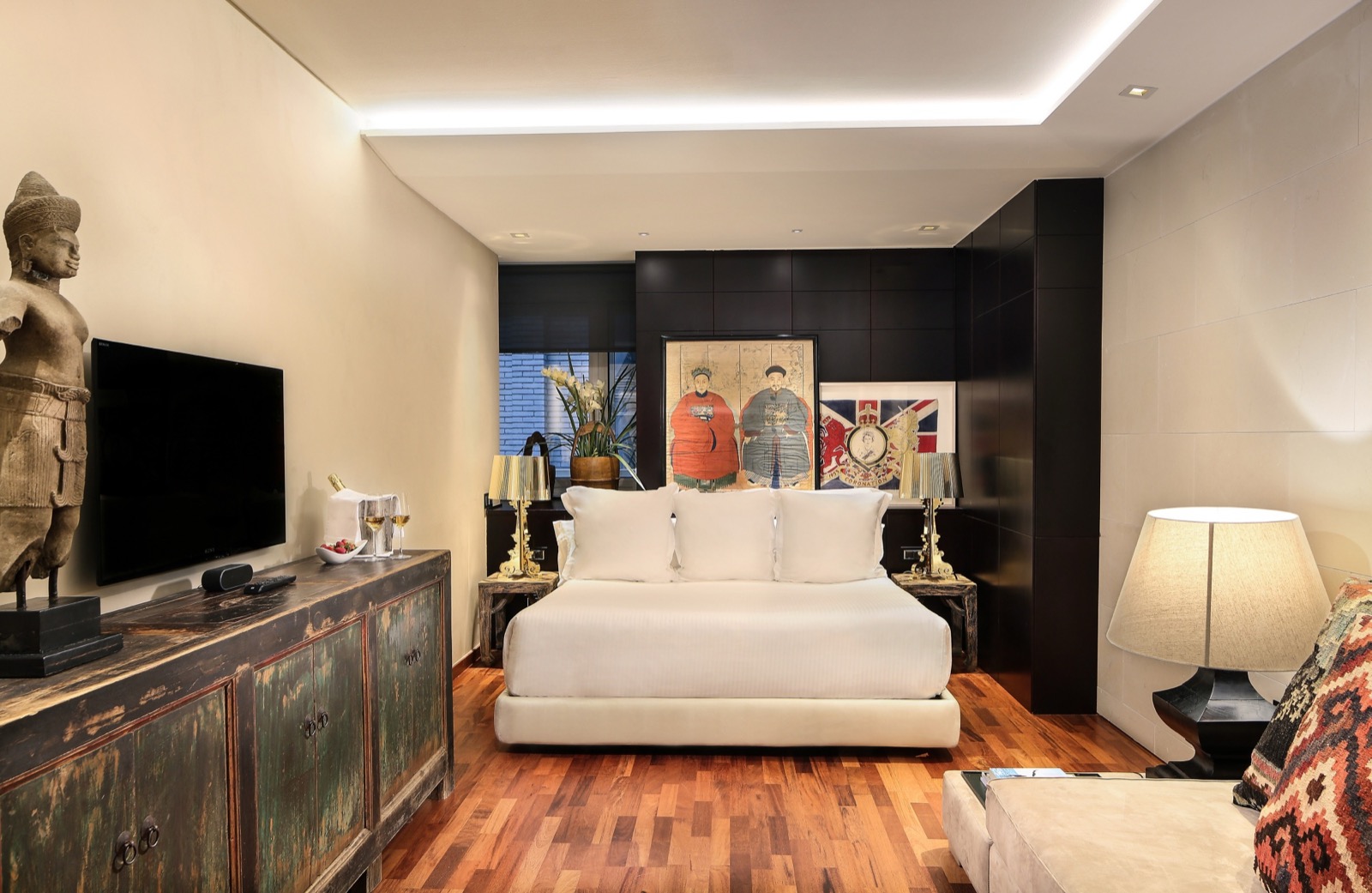 Hotel Claris guest room with a gilded textured headboard