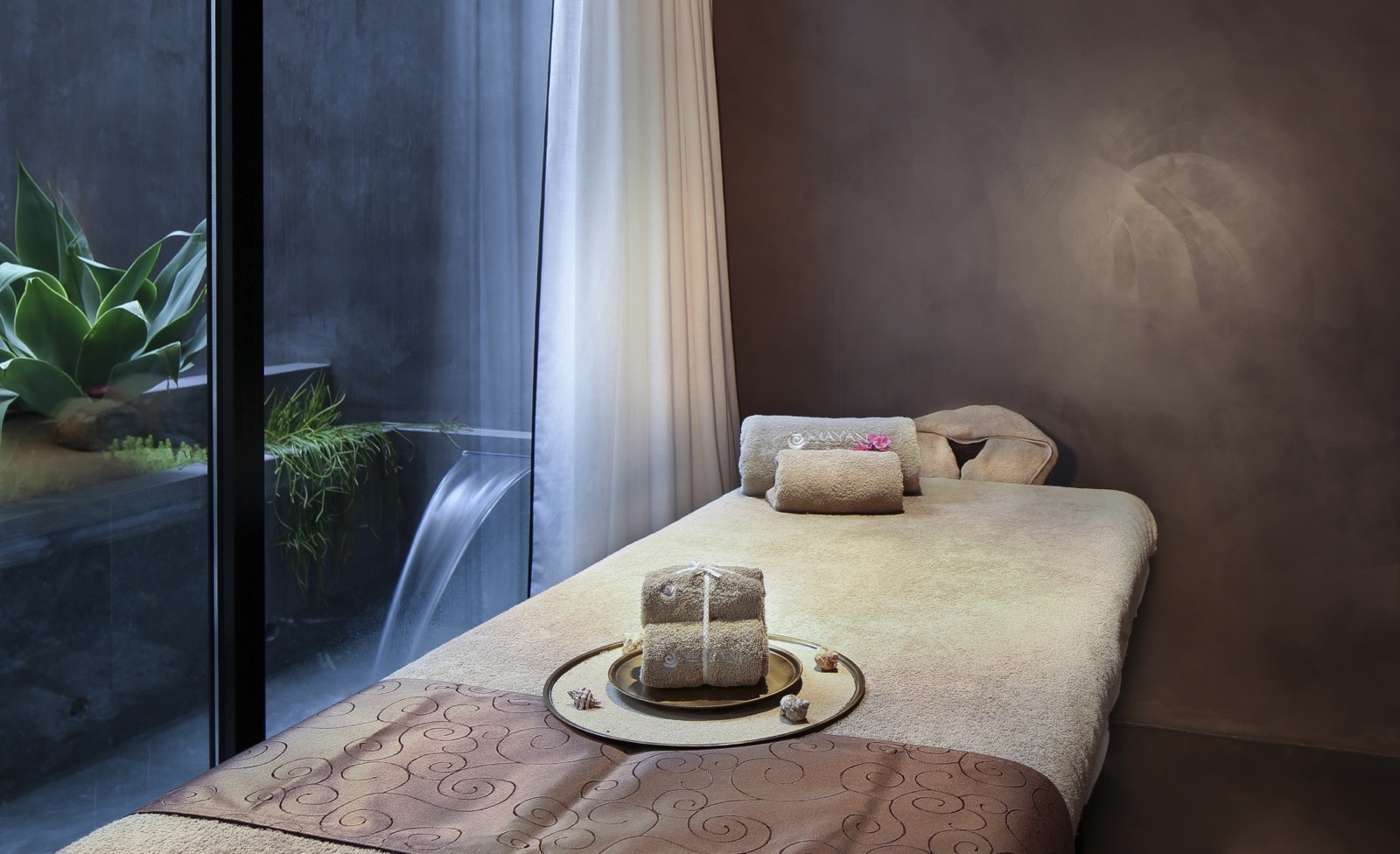 Mayan Secret Spa treatment room at Hotel Claris with a water feature