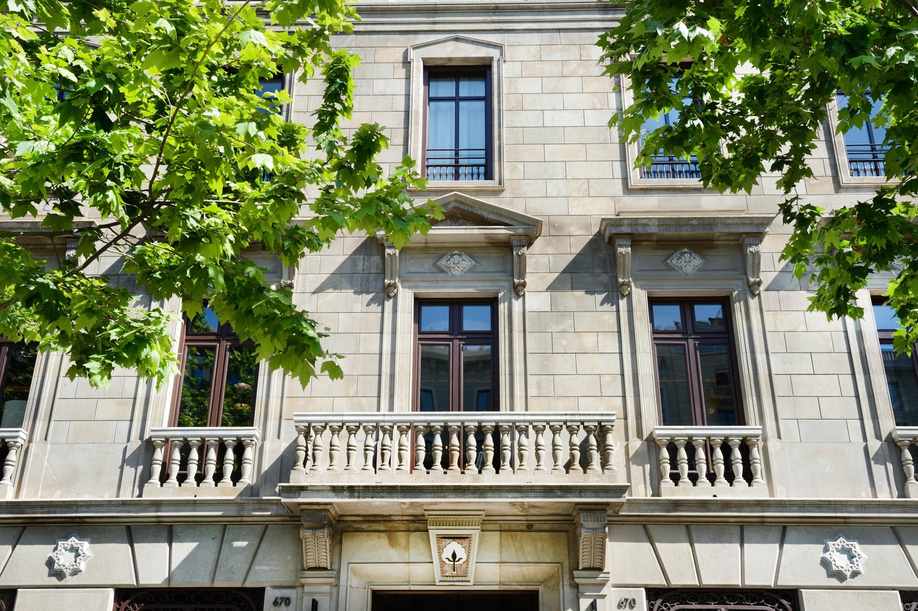 Cotton House Hotel facade with the carved cotton-flower emblem above the entrance