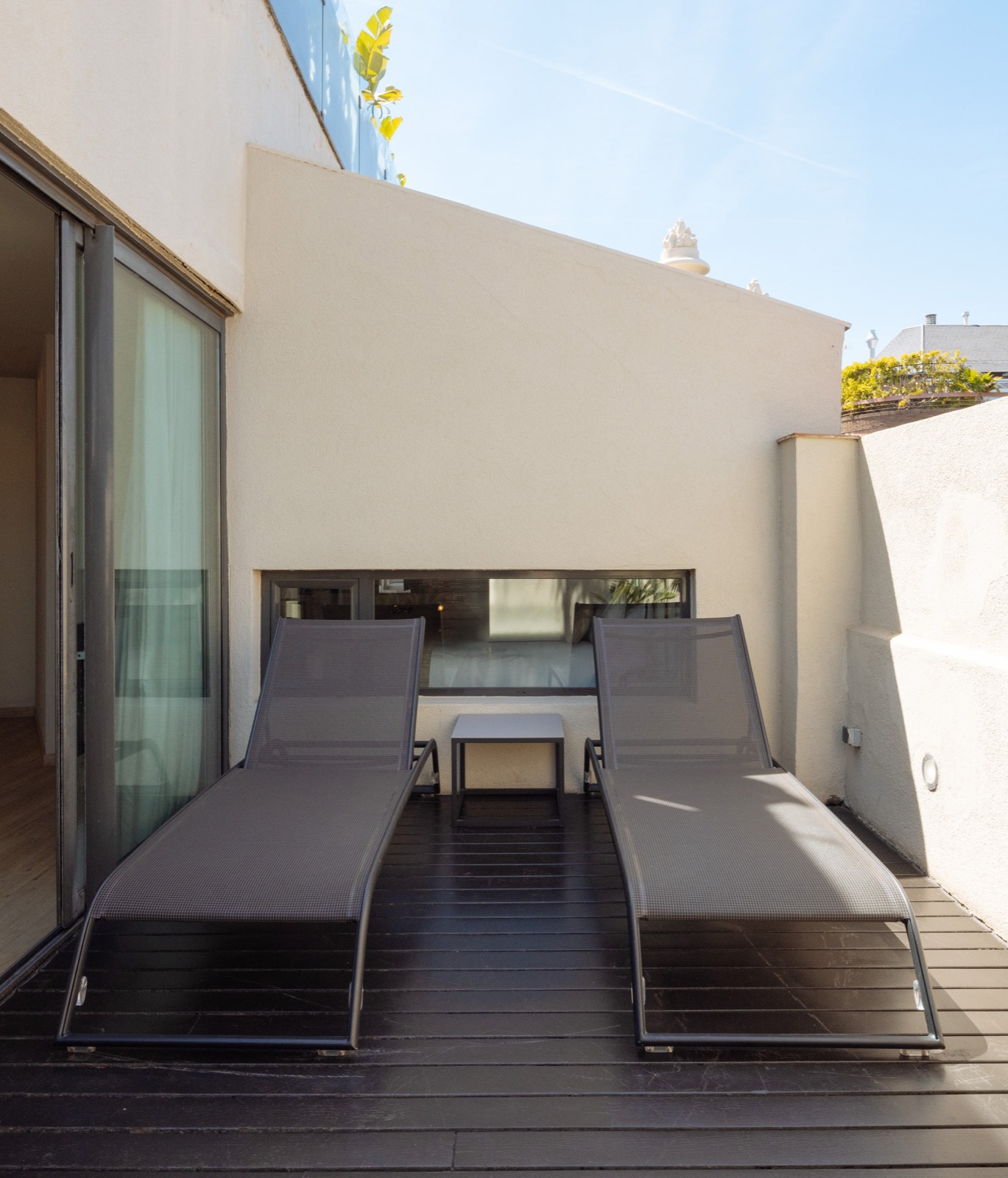 Private rooftop terrace with two loungers outside a guest room