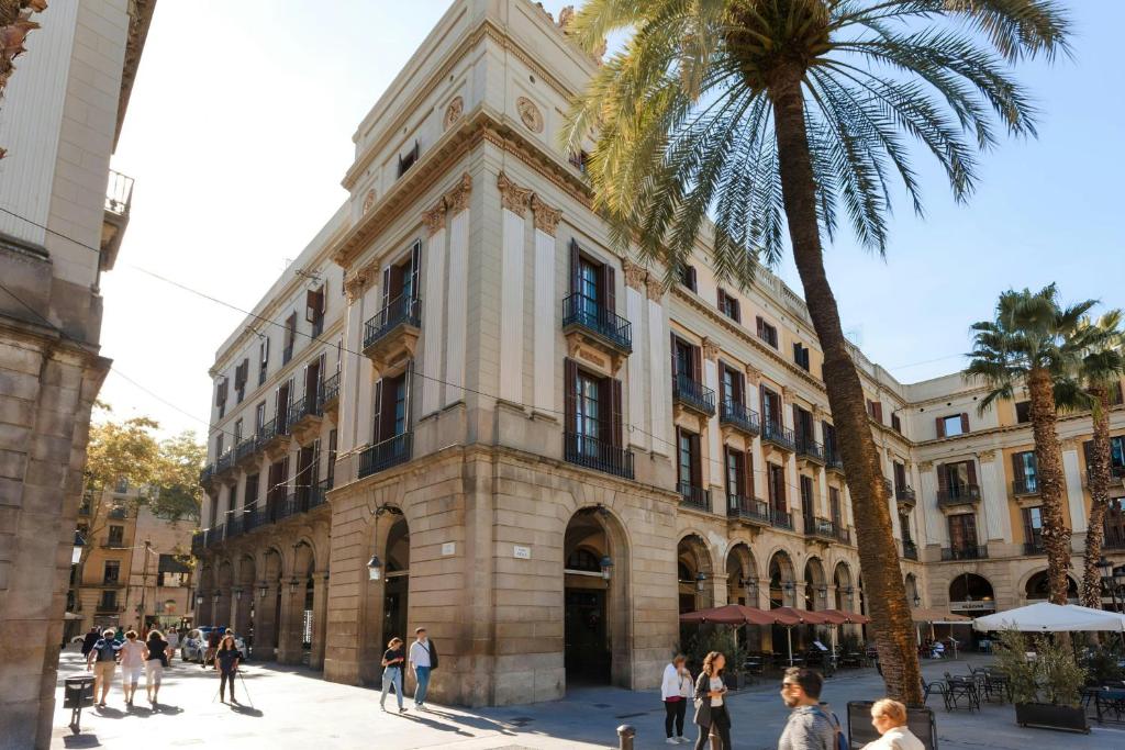 The neoclassical façade of Hotel DO: Plaça Reial on the arcaded Plaça Reial in Barcelona, with shuttered windows and Juliet balconies