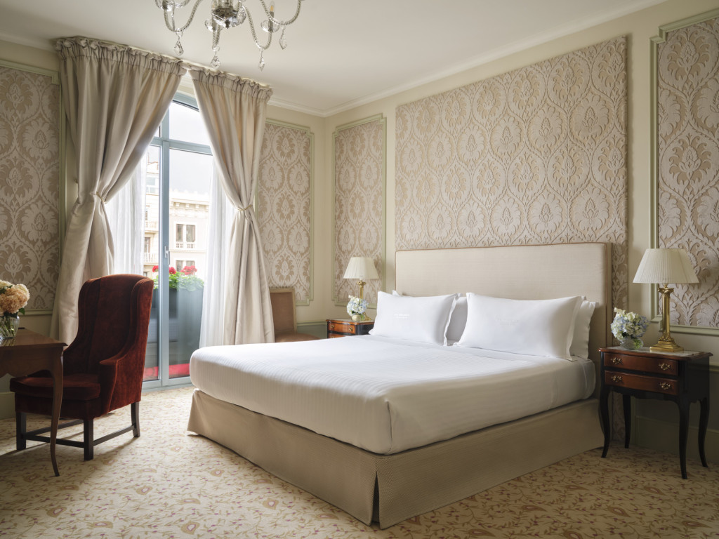 Classic Room with damask-upholstered walls, a canopied bed and balcony doors