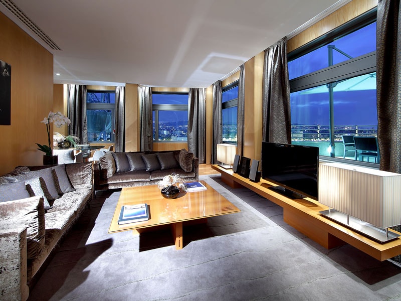 Suite living room with sofas and a city view at night