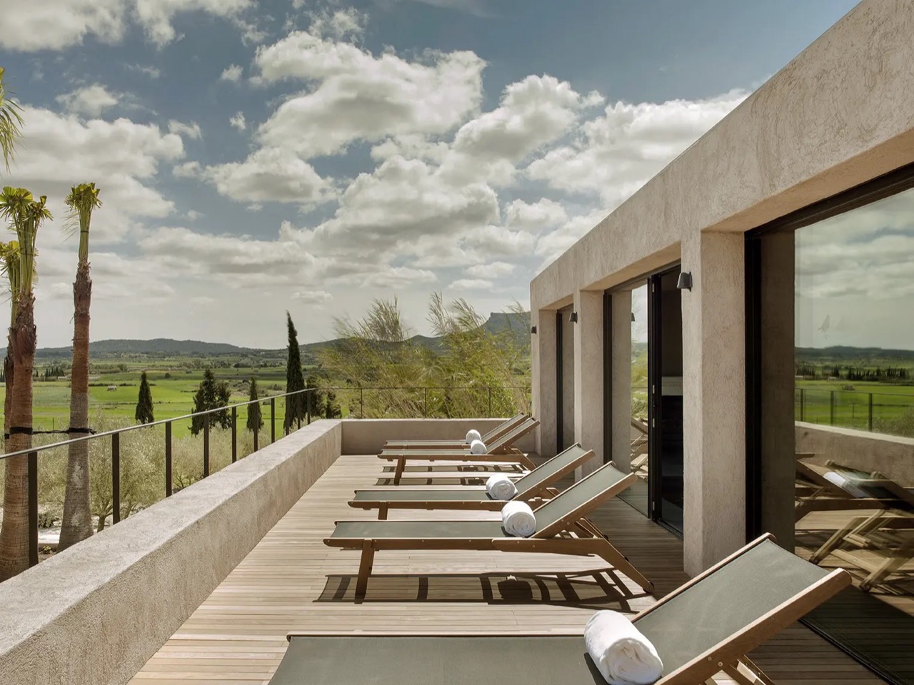Row of sun loungers on the spa terrace at Finca Serena, overlooking the Pla de Mallorca countryside
