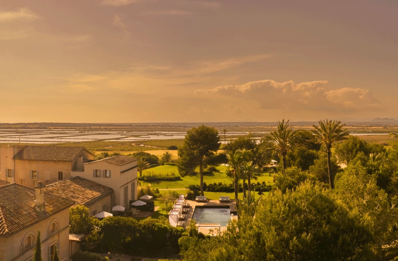 Aerial view of Fontsanta Hotel at sunset showing the main building, pool and surrounding countryside