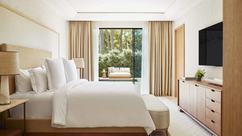 Bedroom with a private terrace and plunge pool opening onto pine trees