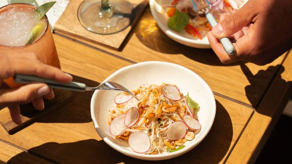 Plated dish and drinks on an outdoor restaurant table