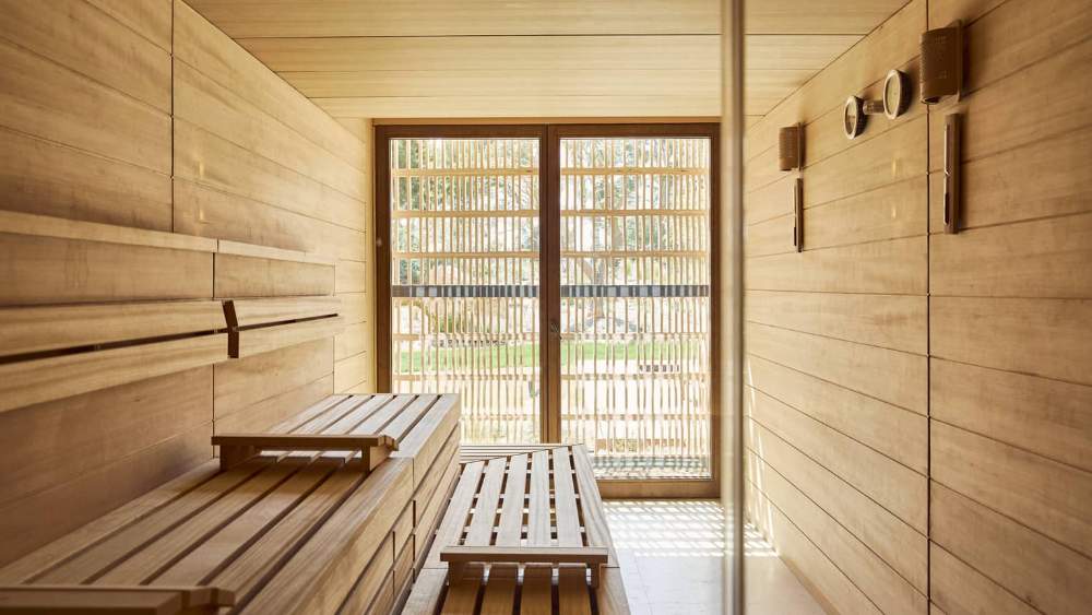 Wood panelled sauna with a garden facing window at the resort spa