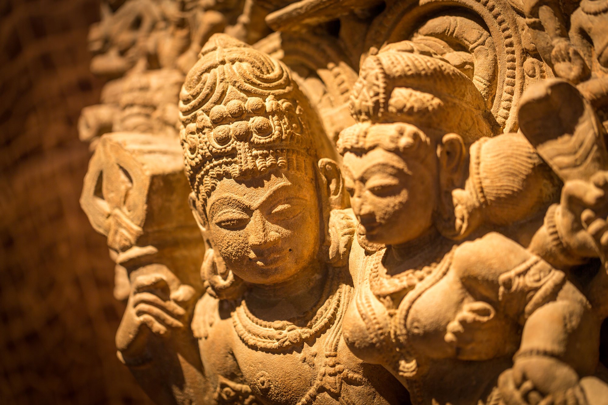 Close-up of a carved stone Hindu sculpture from the art collection displayed at Hotel Granados 83