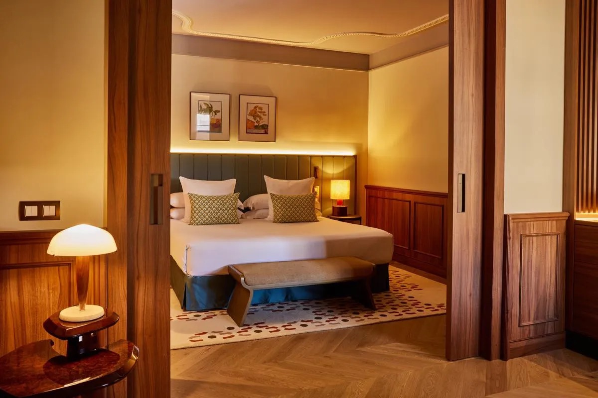 Master Suite bedroom with a green upholstered headboard