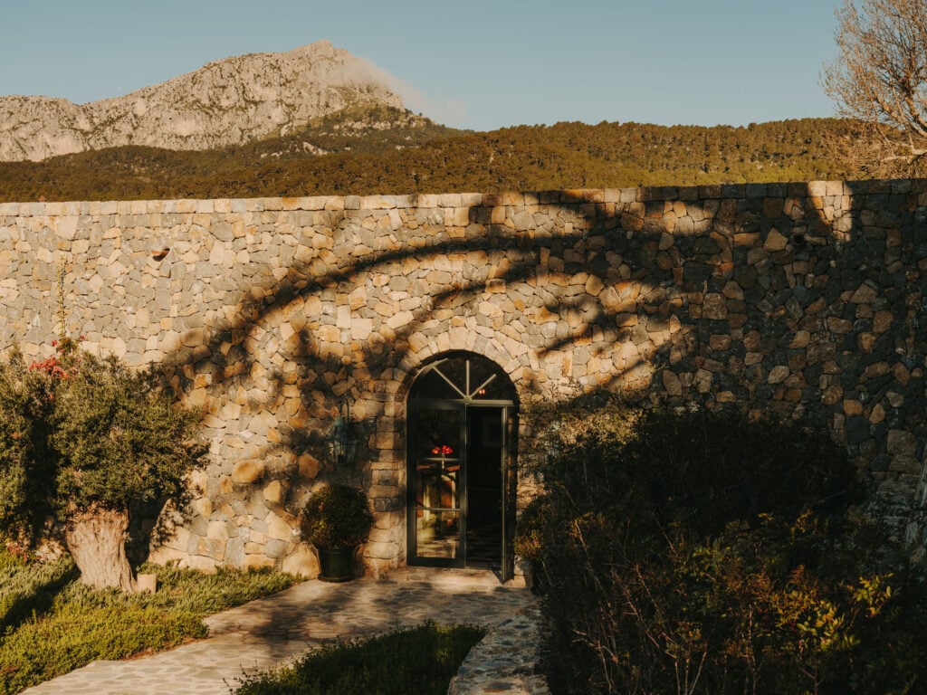 Stone archway entrance to the spa set into a hillside wall